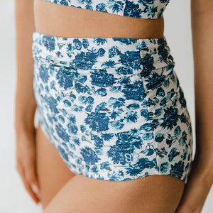 Close up of blue floral and white ruched high waisted swimsuit bottoms