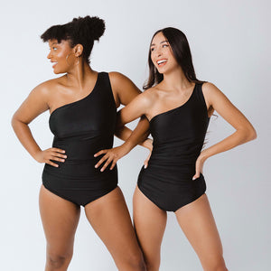 Two models wearing one-shoulder swimsuits