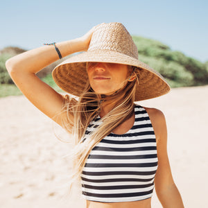 Woman in a striped swim top on the beach